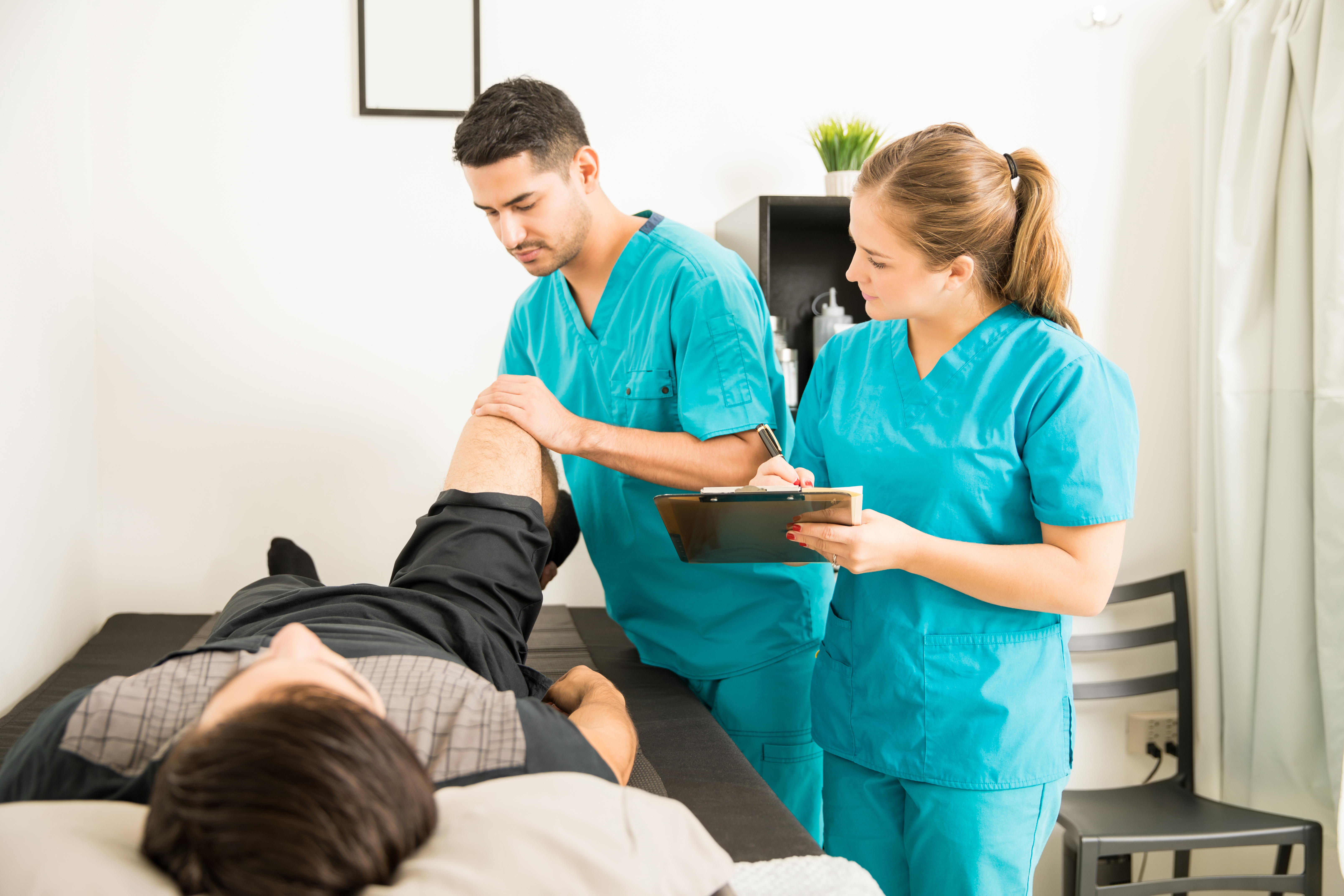 Physiotherapist Examining Patient